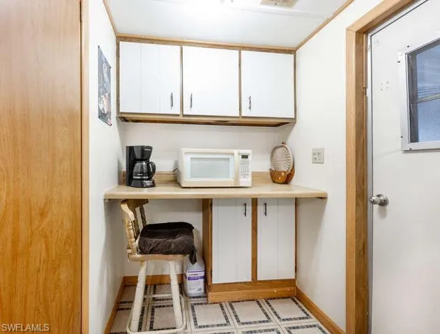 Kitchen featuring white cabinetry