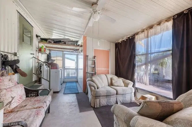 Lanai with ceiling fan, concrete flooring, and washer / clothes dryer