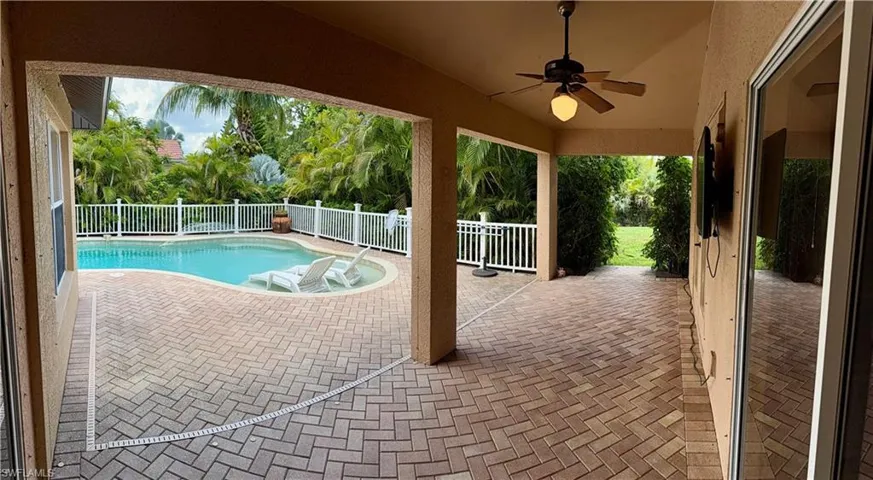 View of swimming pool featuring a patio and a ceiling fan