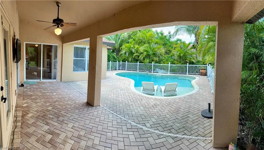 View of swimming pool featuring a fenced backyard, a patio, and ceiling fan