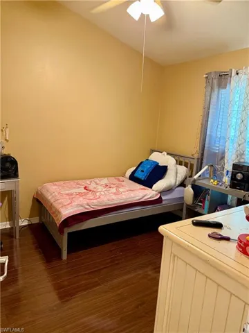 Bedroom featuring dark wood-style floors and a ceiling fan