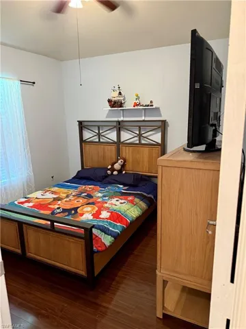 Bedroom featuring wood finished floors and a ceiling fan