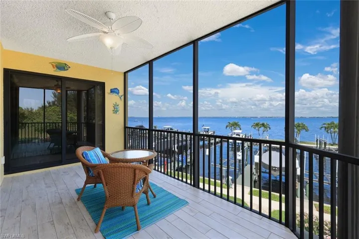 Sunroom featuring a water view and ceiling fan