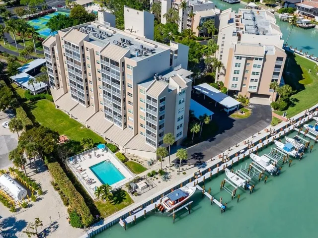 Drone / aerial view of a large body of water and apartment complex / building