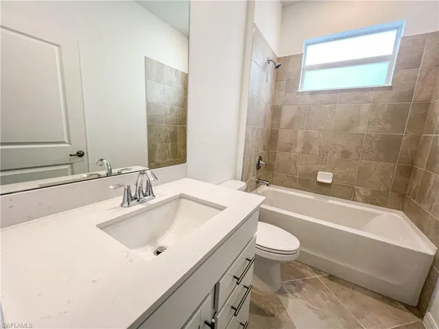 Bathroom with vanity and shower / tub combination