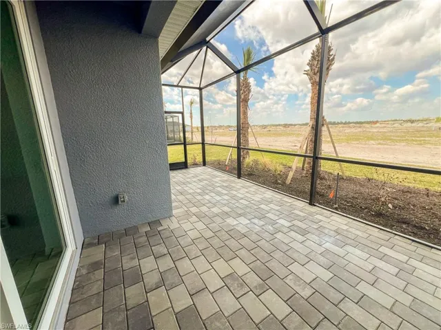 Unfurnished sunroom with a patio