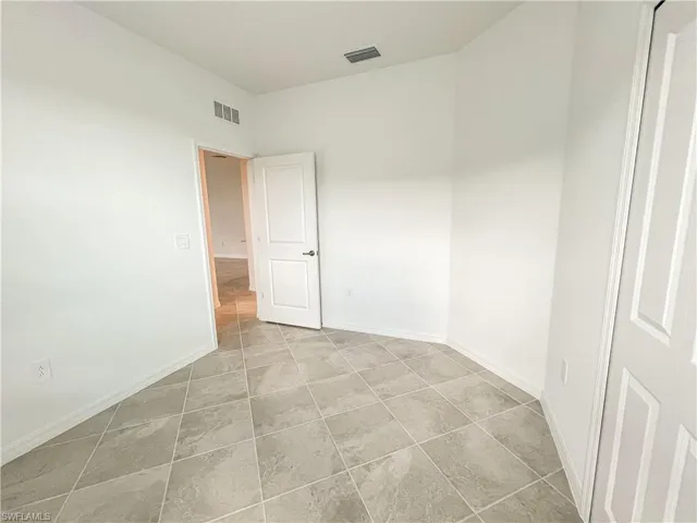 Spare room featuring baseboards