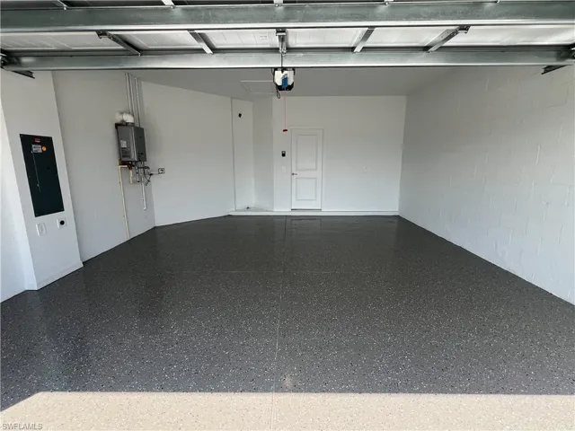 Garage with electric panel and concrete block wall