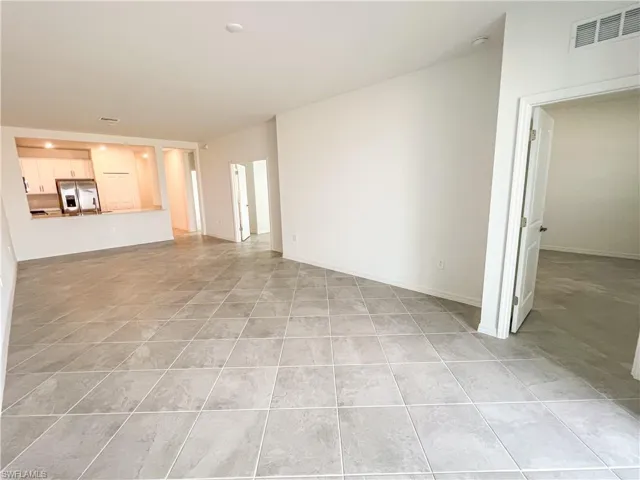 Unfurnished living room featuring baseboards