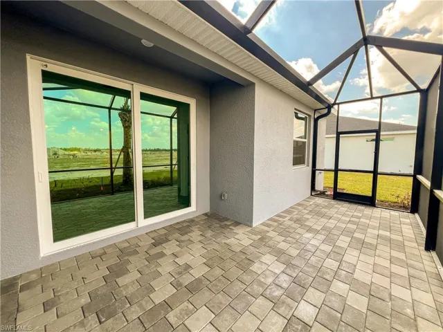 Unfurnished sunroom featuring a patio area