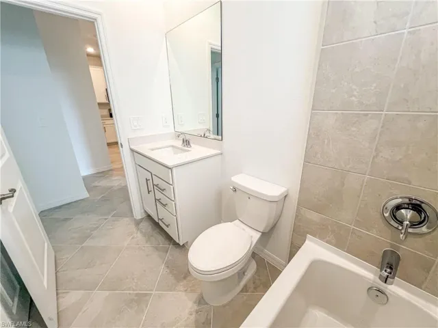 Bathroom with vanity and light tile patterned floors