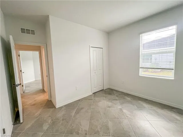Unfurnished bedroom with baseboards and a closet
