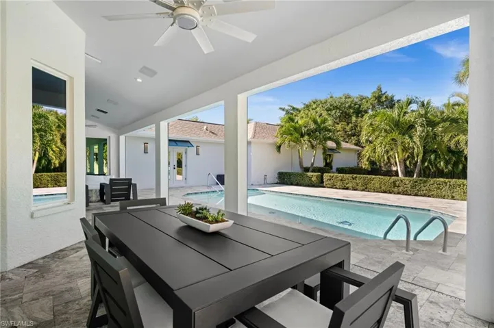 A spacious covered lanai offers seamless transition from the heart of the home to the pool.
