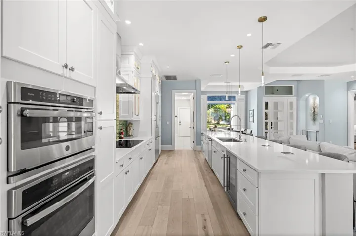 A stunning kitchen with double ovens, induction cooktop, and an expansive island perfect for prepping, serving, and gathering.
