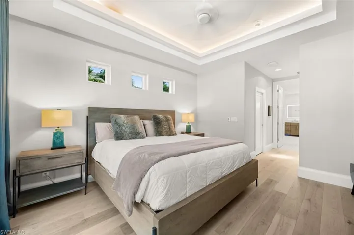 Soft tones, tray ceilings with recessed lighting, and natural light create a peaceful retreat.