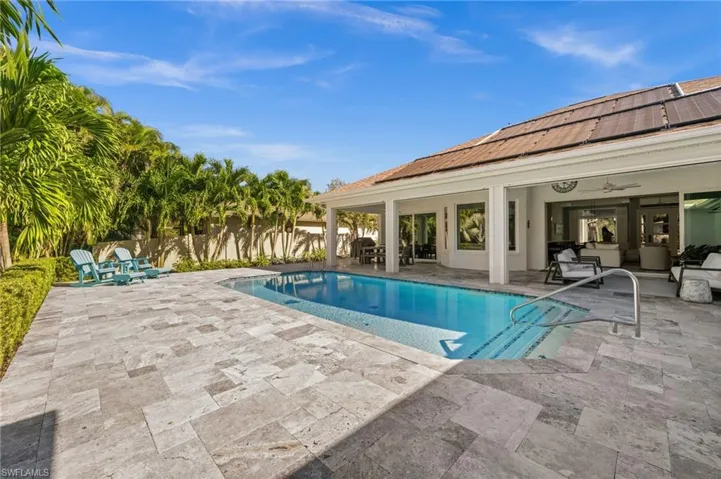 Lush landscaping and a sparkling saltwater pool offer a peaceful retreat for sunny days and starry nights.
