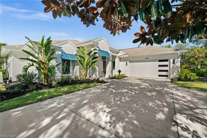 Clean lines, blue awnings, and lush landscaping