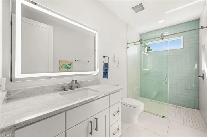 Bright white finishes paired with chic tile detailing for a spa-like feel.