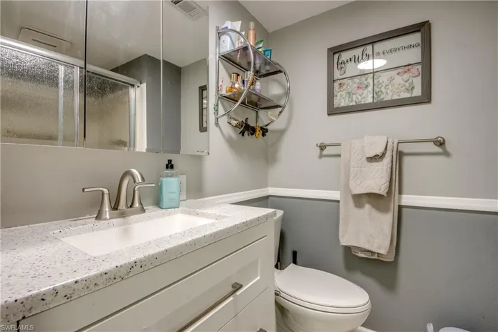 Full bathroom featuring a shower stall and vanity