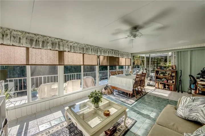 Sunroom / solarium featuring ceiling fan and outdoor dining space
