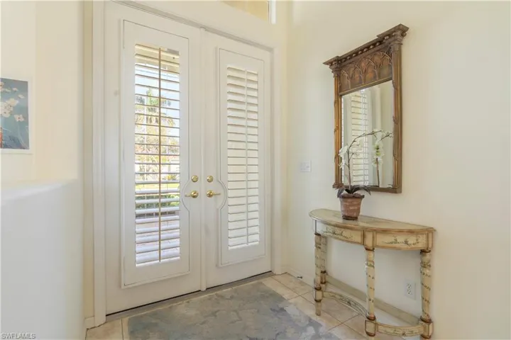 Doorway to outside featuring french doors and light tile patterned floors