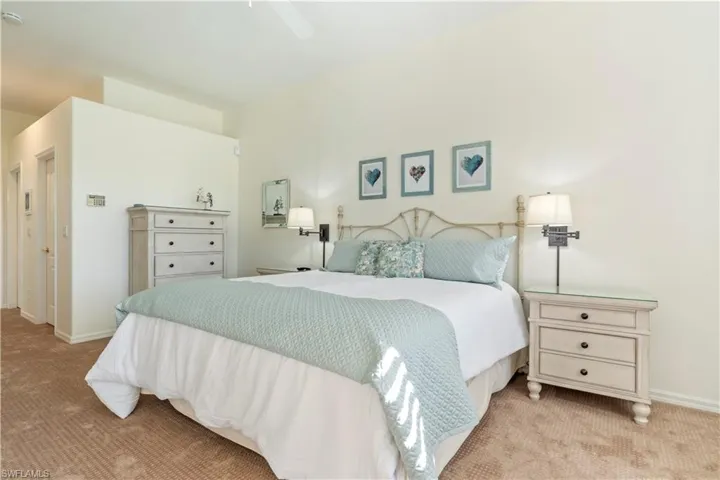 Carpeted bedroom with ceiling fan
