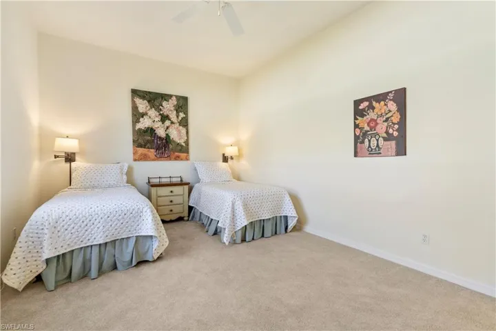 Bedroom featuring light colored carpet and ceiling fan