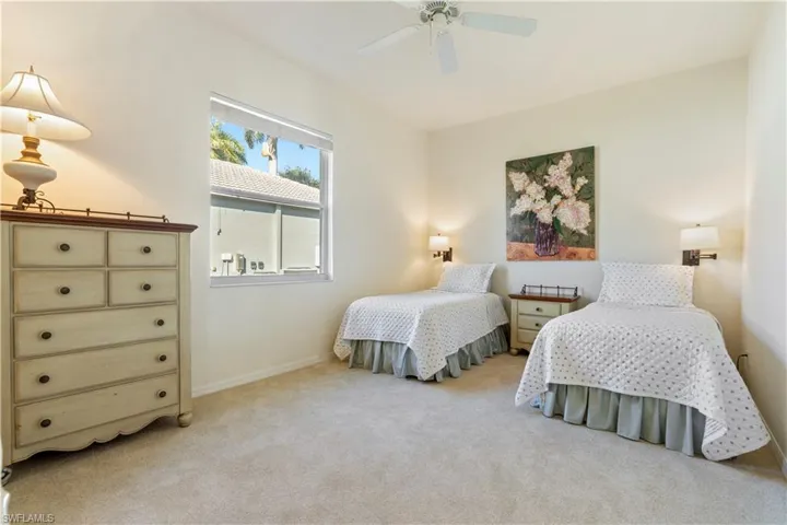 Carpeted bedroom with ceiling fan