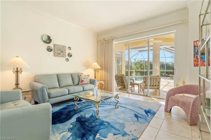 Living room with ornamental molding and light tile patterned floors