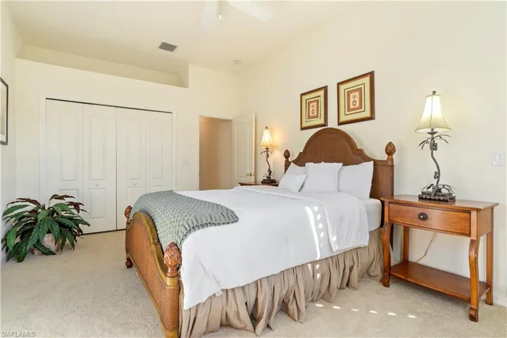 Bedroom featuring light carpet, a closet, and ceiling fan