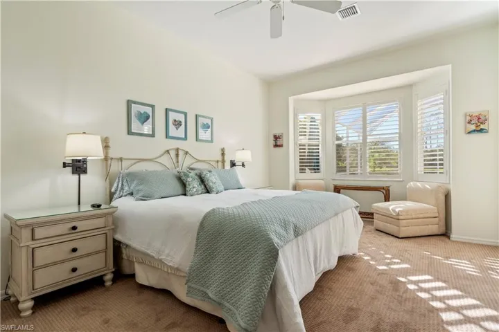 Bedroom featuring ceiling fan and light colored carpet