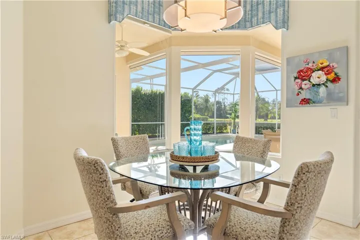 Dining area with ceiling fan and light tile patterned flooring