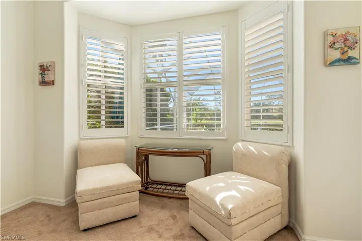 Sitting room with carpet and a healthy amount of sunlight