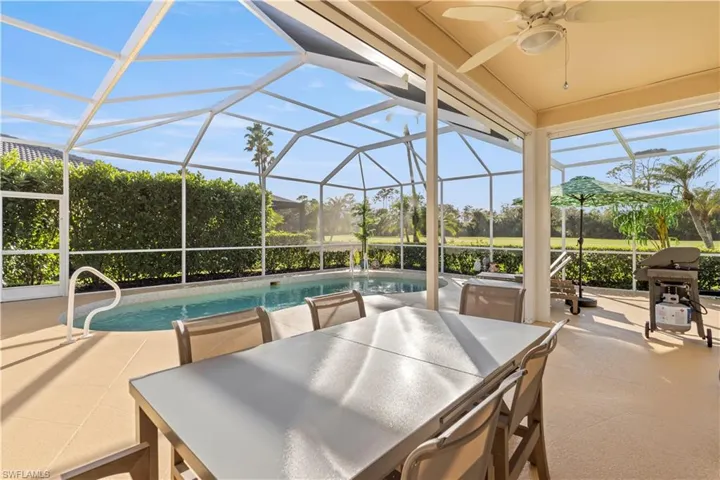 View of patio / terrace featuring glass enclosure and ceiling fan