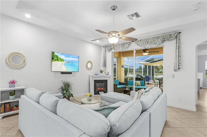 Living room with tray ceiling and large sliders to enjoy outdoor living.