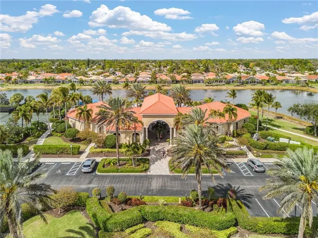 Aerial perspective of suburban area featuring a nearby body of water