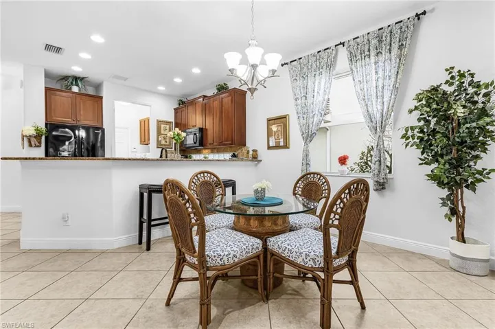 Dining space with a chandelier and light tile patterned flooring
