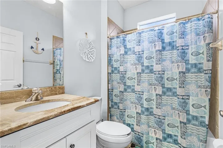 Full HALL bathroom tiled shower over tub.