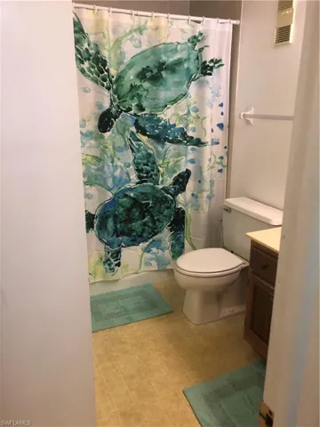 Bathroom with vanity and curtained shower