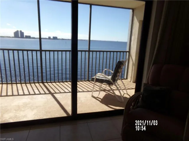 Sunroom featuring a water view