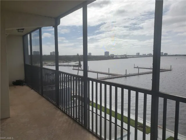 Balcony with a city view, a water view, and a boat dock