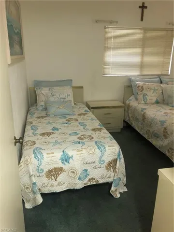 Bedroom featuring dark colored carpet