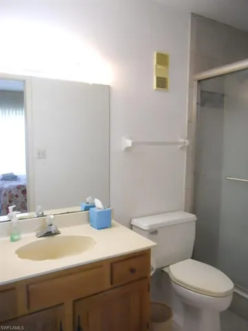 Bathroom with a stall shower and vanity