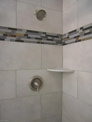 Bathroom view of a tile shower
