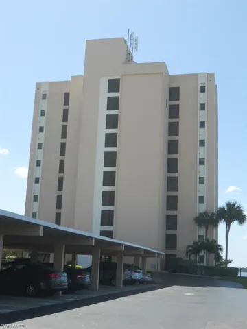 View of property featuring covered parking