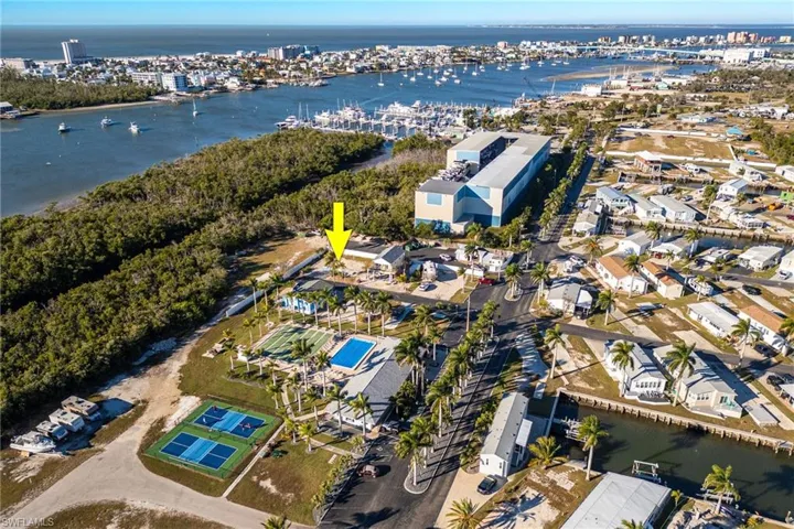 Aerial view of property's location featuring a nearby body of water