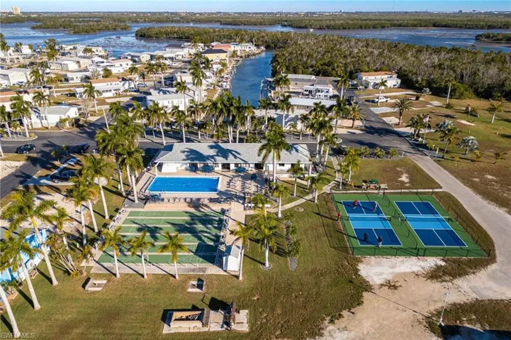 Aerial view of residential area featuring a nearby body of water