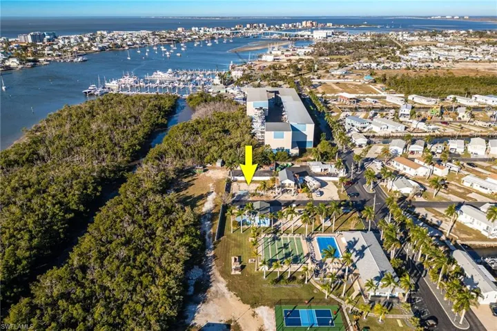 Aerial view of property and surrounding area with a nearby body of water