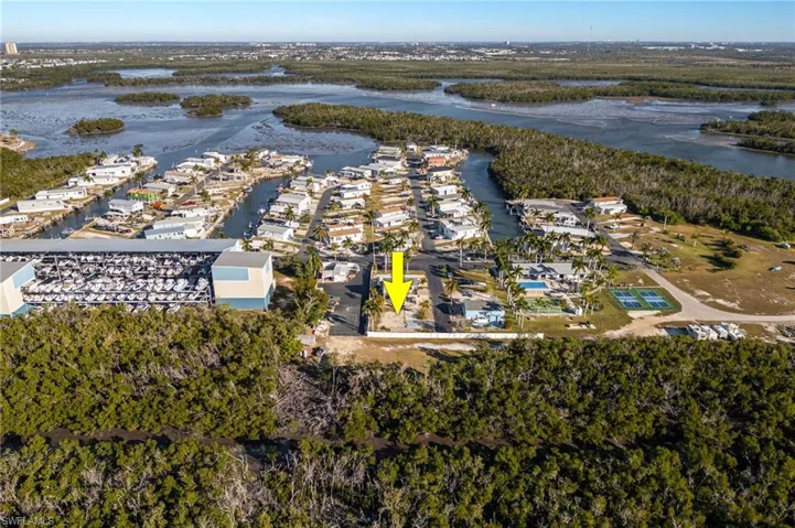 Aerial view of residential area featuring a nearby body of water