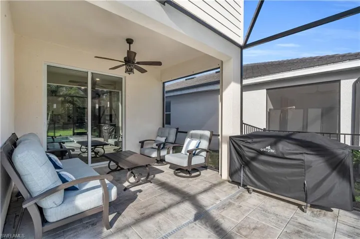 View of patio / terrace featuring a lanai, a grill, and ceiling fan